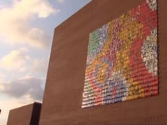 Artist Boris Bally installs large art piece on the exterior of the Omaha JCC